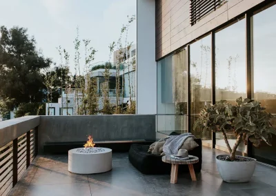 Foyer Belmont en béton clair avec assise intégrée sur une terrasse contemporaine